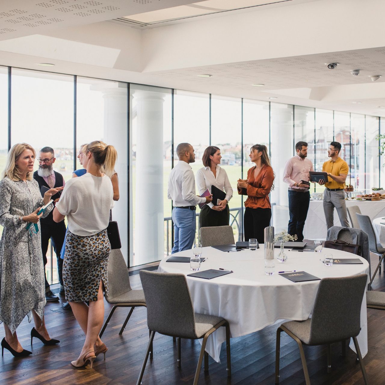 Guests mingling at a conference in a function room
